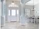 Elegant foyer with view to dining room, featuring tile floors and bright natural light at 12605 Bacchus Rd, Port Charlotte, FL 33981