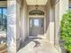 Welcoming front entrance featuring decorative columns and a stylish glass door at 12605 Bacchus Rd, Port Charlotte, FL 33981