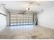 Open garage space with concrete flooring and an automatic garage door at 12605 Bacchus Rd, Port Charlotte, FL 33981