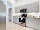 Modern kitchen with stainless steel appliances and ample cabinet space at 12605 Bacchus Rd, Port Charlotte, FL 33981