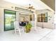 Spacious lanai with seating, ceiling fan, and views of the living room, dining, and backyard at 12605 Bacchus Rd, Port Charlotte, FL 33981