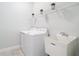 Bright laundry room features white appliances, a utility sink, and wire rack shelving at 12605 Bacchus Rd, Port Charlotte, FL 33981
