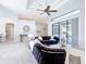 Open concept living room with tile floors, ceiling fan and sliding glass doors to the lanai at 12605 Bacchus Rd, Port Charlotte, FL 33981