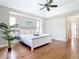 Beautifully staged main bedroom with hardwood floors, tray ceiling, and decorative plant at 12605 Bacchus Rd, Port Charlotte, FL 33981