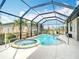 Relaxing screened-in pool area featuring a pool and spa, perfect for outdoor entertaining at 12605 Bacchus Rd, Port Charlotte, FL 33981
