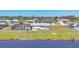 Aerial view of the home, pool, and expansive backyard with water views at 13 Caddy Rd, Rotonda West, FL 33947