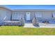Charming entrance with stone accents, well-manicured lawn, and quaint lighting at 13 Caddy Rd, Rotonda West, FL 33947