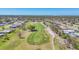 Aerial view showcasing a golf course and residences within the community at 13 Caddy Rd, Rotonda West, FL 33947