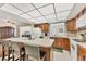 Bright kitchen with center island and breakfast bar seating, open to living area at 13 Caddy Rd, Rotonda West, FL 33947