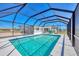 Screened pool with clear blue water and ample deck space for relaxation at 13 Caddy Rd, Rotonda West, FL 33947