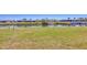 The backyard has a canal water view beyond the fenced yard at 13 Caddy Rd, Rotonda West, FL 33947