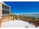 Outdoor deck with waterfront view featuring white flooring and wood railing, ideal for relaxation and coastal living at 1401 Beach Rd # 304, Englewood, FL 34223