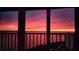 Balcony view of a beautiful pink and purple sunset over the water, creating a serene and picturesque scene at 1401 Beach Rd # 304, Englewood, FL 34223