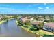 Beautiful aerial view of lakefront properties, screens, and lush mature landscaping at 14236 Silver Lakes Cir, Port Charlotte, FL 33953