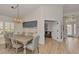 Dining area with light wood table, light color chairs, and beach themed artwork at 14236 Silver Lakes Cir, Port Charlotte, FL 33953