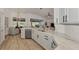 Kitchen island with marble countertop overlooks a living area with natural light at 14236 Silver Lakes Cir, Port Charlotte, FL 33953