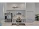 Modern kitchen features light gray cabinets, stainless steel appliances, and unique fish decor at 14236 Silver Lakes Cir, Port Charlotte, FL 33953