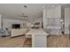 Open concept living space with island, light cabinets, wood floor, and vaulted ceilings at 14236 Silver Lakes Cir, Port Charlotte, FL 33953