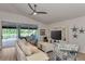 Open living room with large glass doors leading to the lanai and offering backyard views at 14236 Silver Lakes Cir, Port Charlotte, FL 33953