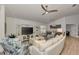 Comfortable living room with ceiling fan, entertainment center, and views into the dining area at 14236 Silver Lakes Cir, Port Charlotte, FL 33953