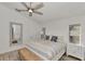 Bright main bedroom with a king bed, ceiling fan, bench, and views of the outdoors at 14236 Silver Lakes Cir, Port Charlotte, FL 33953