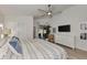 Spacious main bedroom featuring a ceiling fan, TV, and sliding glass doors to the backyard at 14236 Silver Lakes Cir, Port Charlotte, FL 33953