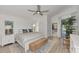Bright main bedroom featuring a king bed, ensuite bathroom, and private access to the outdoors at 14236 Silver Lakes Cir, Port Charlotte, FL 33953