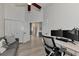 Open office space features a vaulted ceiling, wood floors, and a modern desk setup for efficient work at 14236 Silver Lakes Cir, Port Charlotte, FL 33953