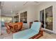 Covered patio has a dining area, chaise lounge, and seamless access to the home's interior for outdoor enjoyment at 14236 Silver Lakes Cir, Port Charlotte, FL 33953