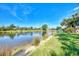 Beautiful pond view highlighting the serene water, landscaping, and nearby homes at 14236 Silver Lakes Cir, Port Charlotte, FL 33953