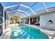 The screened-in pool area seamlessly integrates with the home's design, offering an enjoyable outdoor space with lake views at 14236 Silver Lakes Cir, Port Charlotte, FL 33953