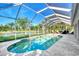 Enclosed pool area provides a private oasis for relaxation and recreation, with serene views of the adjacent lake at 14236 Silver Lakes Cir, Port Charlotte, FL 33953