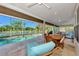 The screened-in pool area offers stunning lake views and seamless transitions to the home's dining and lounging spaces at 14236 Silver Lakes Cir, Port Charlotte, FL 33953