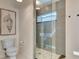 Modern shower with glass surround, rain shower head, gray tile and river rock floor at 14236 Silver Lakes Cir, Port Charlotte, FL 33953