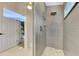 Modern shower with glass surround, rain shower head, gray tile and river rock floor at 14236 Silver Lakes Cir, Port Charlotte, FL 33953