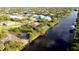 An aerial view highlights the property's waterfront location and the surrounding residential neighborhood at 14246 Maysville, Port Charlotte, FL 33981