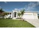 Charming modern home with well-manicured lawn, lush landscaping, and a spacious three-car garage at 14246 Maysville, Port Charlotte, FL 33981