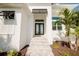 Inviting front entrance featuring a modern double-door entry and lush landscaping at 14246 Maysville, Port Charlotte, FL 33981