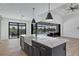 Stylish kitchen island with views of the backyard pool and dining area at 14246 Maysville, Port Charlotte, FL 33981