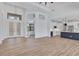 Open-concept living room showcasing wood floors and seamless flow to the kitchen at 14246 Maysville, Port Charlotte, FL 33981