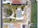 Aerial view of the back of the property with a partially fenced in yard with beach access and boat lift at 1432 Lemon Bay Dr, Englewood, FL 34223