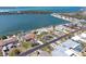 This aerial view shows the home nestled among the homes with easy access to the inter coastal waters at 1432 Lemon Bay Dr, Englewood, FL 34223