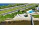 Aerial view showcasing the beach, community pool, and convenient access to the main highway at 14459 River Beach Dr # 129, Port Charlotte, FL 33953