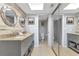 Spacious double sink vanity with large mirrors, plenty of storage, and sliding door to separate commode at 14459 River Beach Dr # 129, Port Charlotte, FL 33953