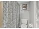 Cozy bathroom features a decorative shower curtain, artwork, and storage for an organized space at 14459 River Beach Dr # 129, Port Charlotte, FL 33953