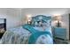 Bedroom showcasing turquoise accents, coastal decor, and comfortable furnishings at 14459 River Beach Dr # 129, Port Charlotte, FL 33953