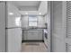 Galley kitchen with white appliances, gray countertops and tile flooring at 14459 River Beach Dr # 129, Port Charlotte, FL 33953