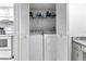 Laundry area includes white washer and dryer, storage shelves, and is adjacent to the kitchen at 14459 River Beach Dr # 129, Port Charlotte, FL 33953