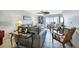 Cozy living room with plush seating, tile floors and sliding doors to a balcony at 14459 River Beach Dr # 129, Port Charlotte, FL 33953
