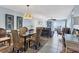 Open living area with woven dining set, plush seating, tile floors and natural light at 14459 River Beach Dr # 129, Port Charlotte, FL 33953